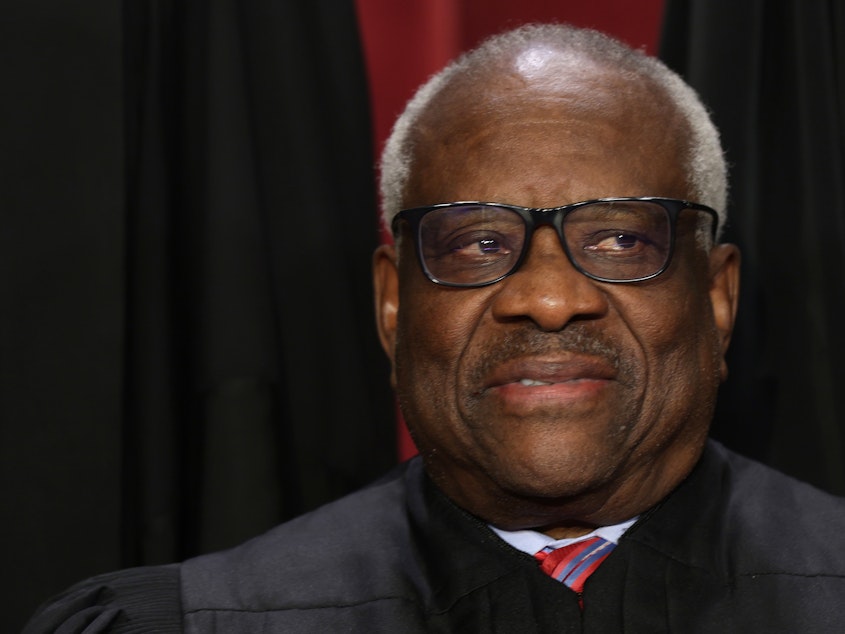 caption: Supreme Court Associate Justice Clarence Thomas poses for an official portrait at the East Conference Room of the Supreme Court building last year.