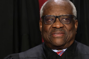 caption: Supreme Court Associate Justice Clarence Thomas poses for an official portrait at the East Conference Room of the Supreme Court building last year.