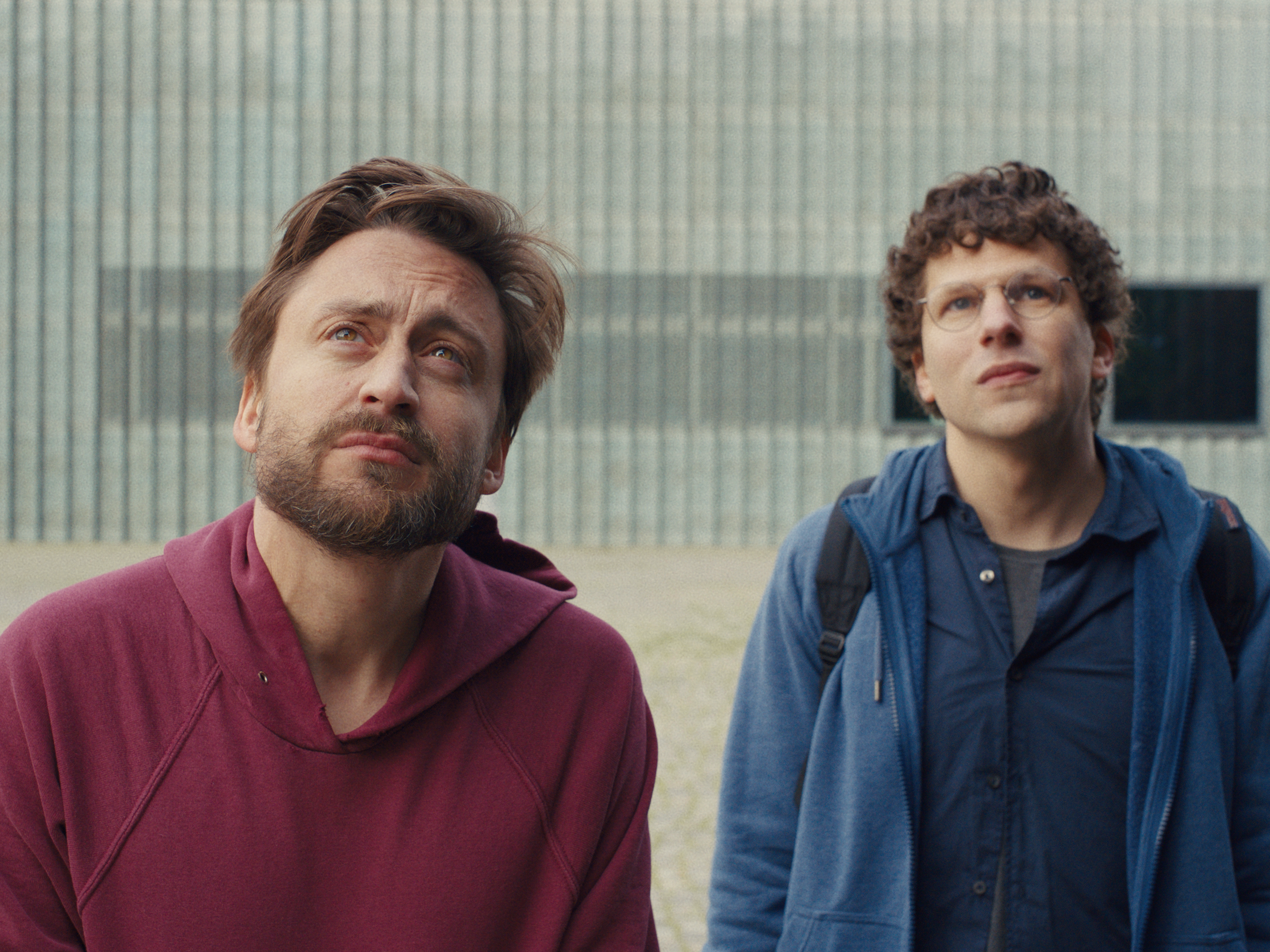 caption: Cousins Benji (Kieran Culkin) and David (Jesse Eisenberg) tour through Poland to honor their beloved grandmother in <em>A Real Pain.</em>