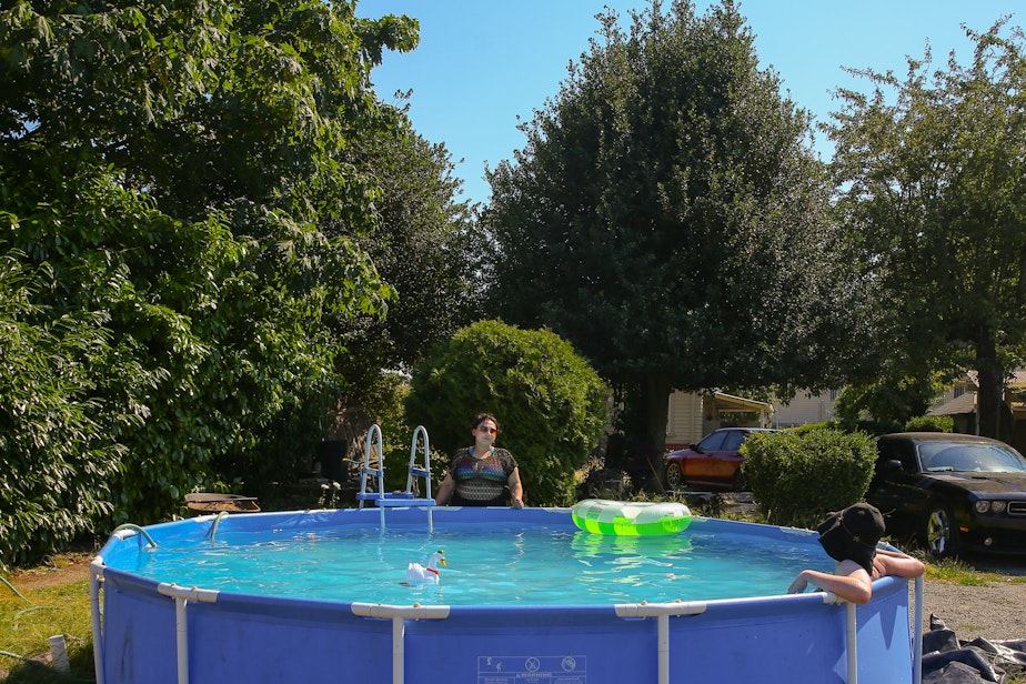 caption: Vickie Boosinger cools off in her pool as she talks to her cousin Jhossy Caceres, in Skyway, Monday, June 28. The National Weather Service recorded 108 degrees in SeaTac on Monday, setting an all-time record for the area. A car temperature gauge recorded 109 degrees in Skyway at 4:30 pm.