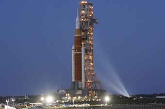 caption: The NASA Artemis 1 rocket with the Orion spacecraft aboard moves slowly on an 11 hour journey to a launch pad at the Kennedy Space Center in Cape Canaveral, Fla., on Thursday, March 17, 2022.