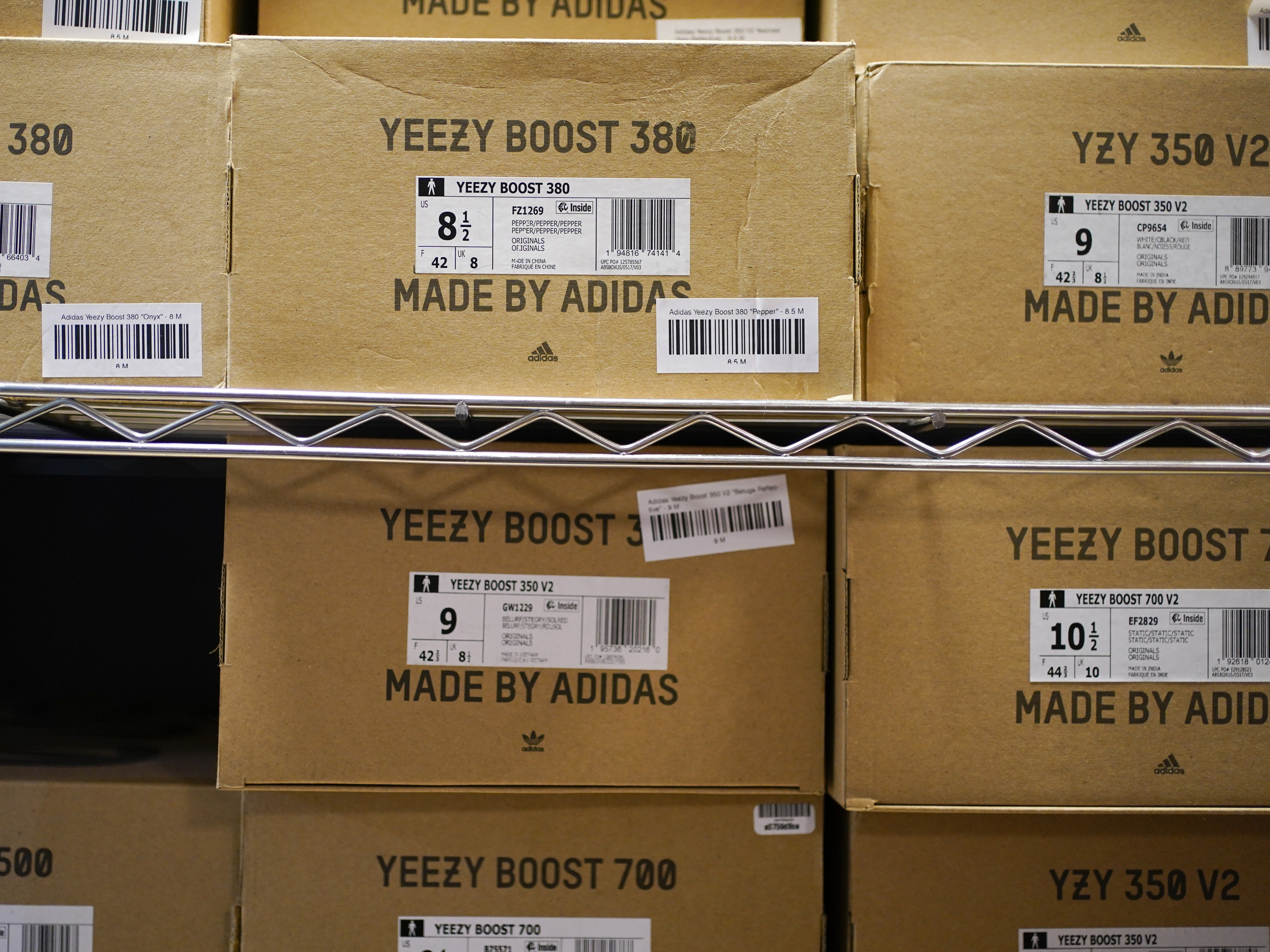 caption: Boxes containing Yeezy shoes made by Adidas are seen at Laced Up, a sneaker resale store, in Paramus, N.J., on Oct. 25, 2022. Adidas' breakup with the rapper formerly known as Kanye West and the inability to sell his popular Yeezy line of shoes helped batter the company's earnings at the end of last year.