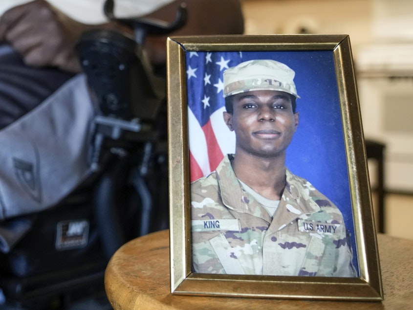 caption: A portrait of Army Pvt. Travis King is displayed as his grandfather, Carl Gates, talks about his grandson on July 19, 2023, in Kenosha, Wis.