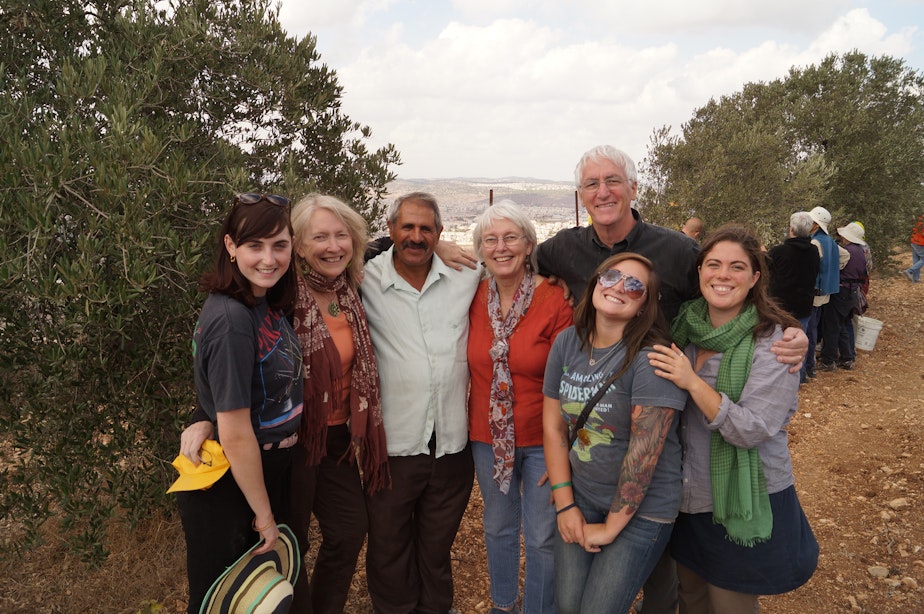 caption: The Corries and Washington state members of the October 2012 Interfaith Peace Builders' olive harvest delegation pose with Palestinian Daher Nassar, third from left, who has been fighting for decades to retain ownership of his family's West Bank farmland on a hilltop south of Bethlehem.