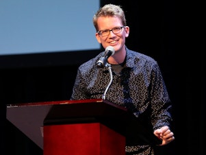 caption: YouTube personality and author Hank Green speaks on stage as he discusses his new book, <em>An Absolutely Remarkable Thing</em> in New York City on Sept. 25, 2018.