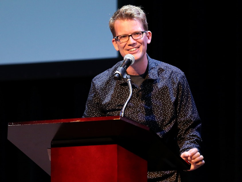 caption: YouTube personality and author Hank Green speaks on stage as he discusses his new book, <em>An Absolutely Remarkable Thing</em> in New York City on Sept. 25, 2018.