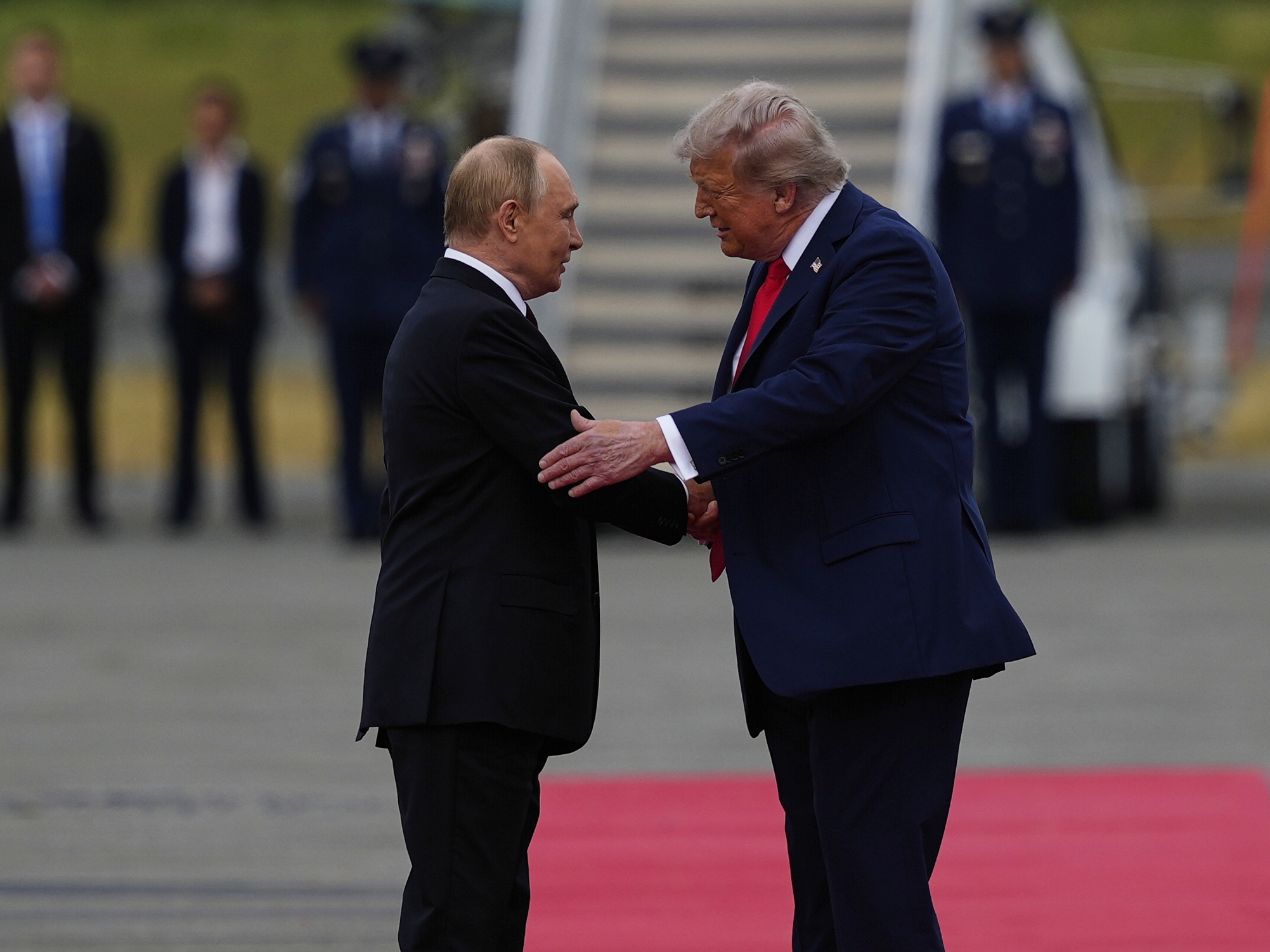 caption: President Donald Trump greets Russia's President Vladimir Putin Friday, Aug. 15, 2025, at Joint Base Elmendorf-Richardson, Alaska.