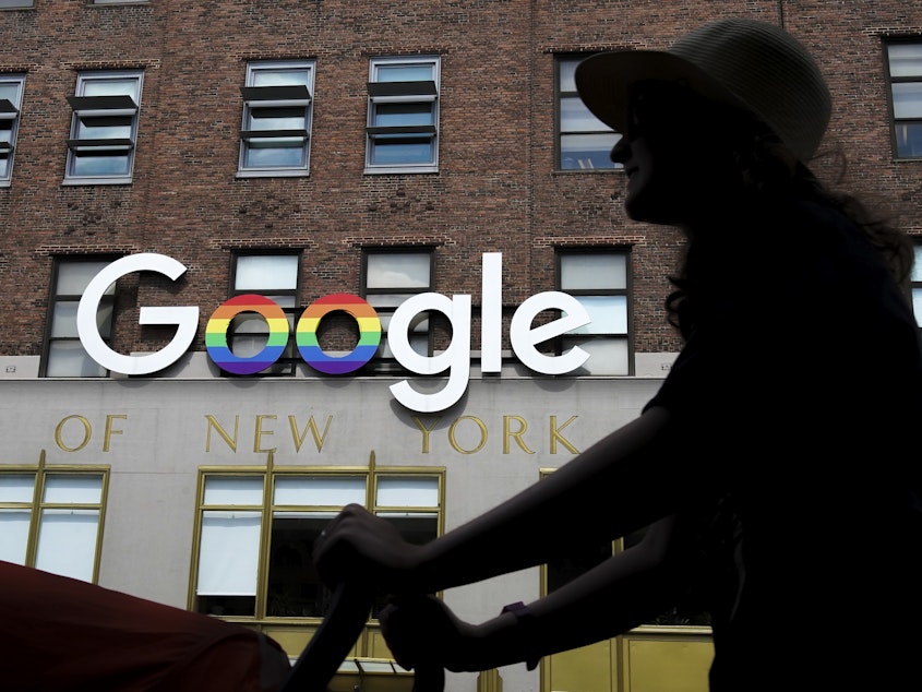 caption: The Google logo adorns the outside of the company's New York City office building. The stock market is hitting records, in large part because of a handful of superstar tech stocks, including Alphabet, Google's parent company.