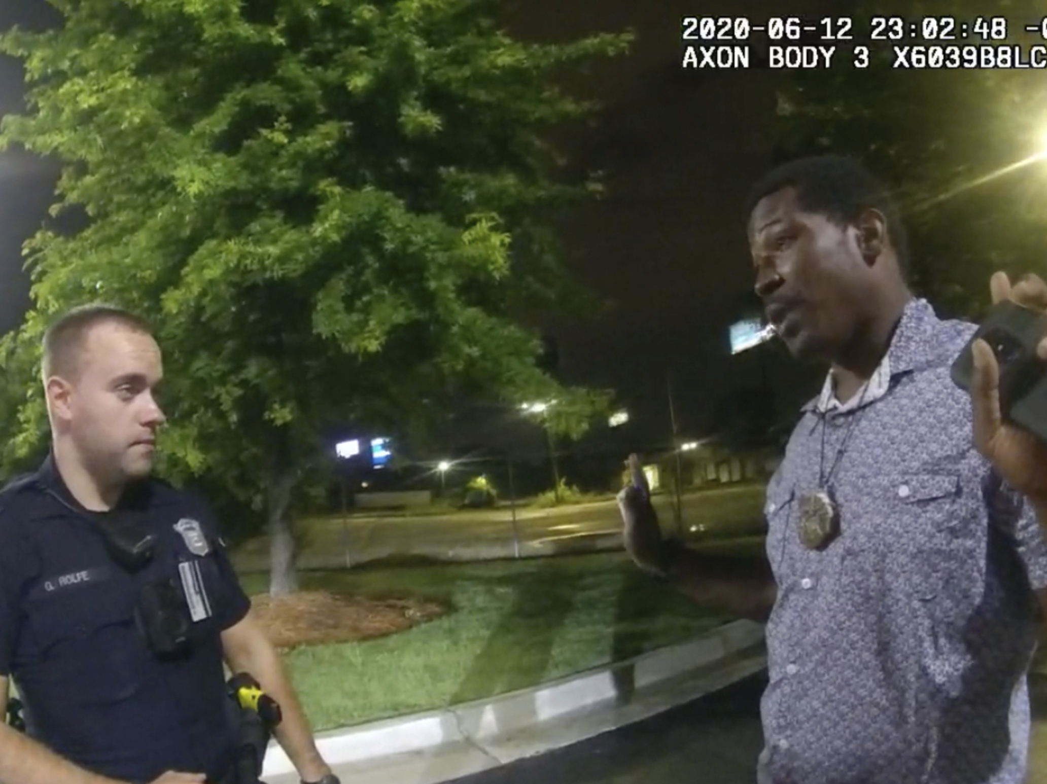 caption: This screen grab taken from body camera video provided by the Atlanta Police Department shows Rayshard Brooks speaking with Officer Garrett Rolfe in the parking lot of a Wendy's restaurant on June 12 in Atlanta. Rolfe has been fired following the fatal shooting of Brooks, and a second officer has been placed on administrative duty.