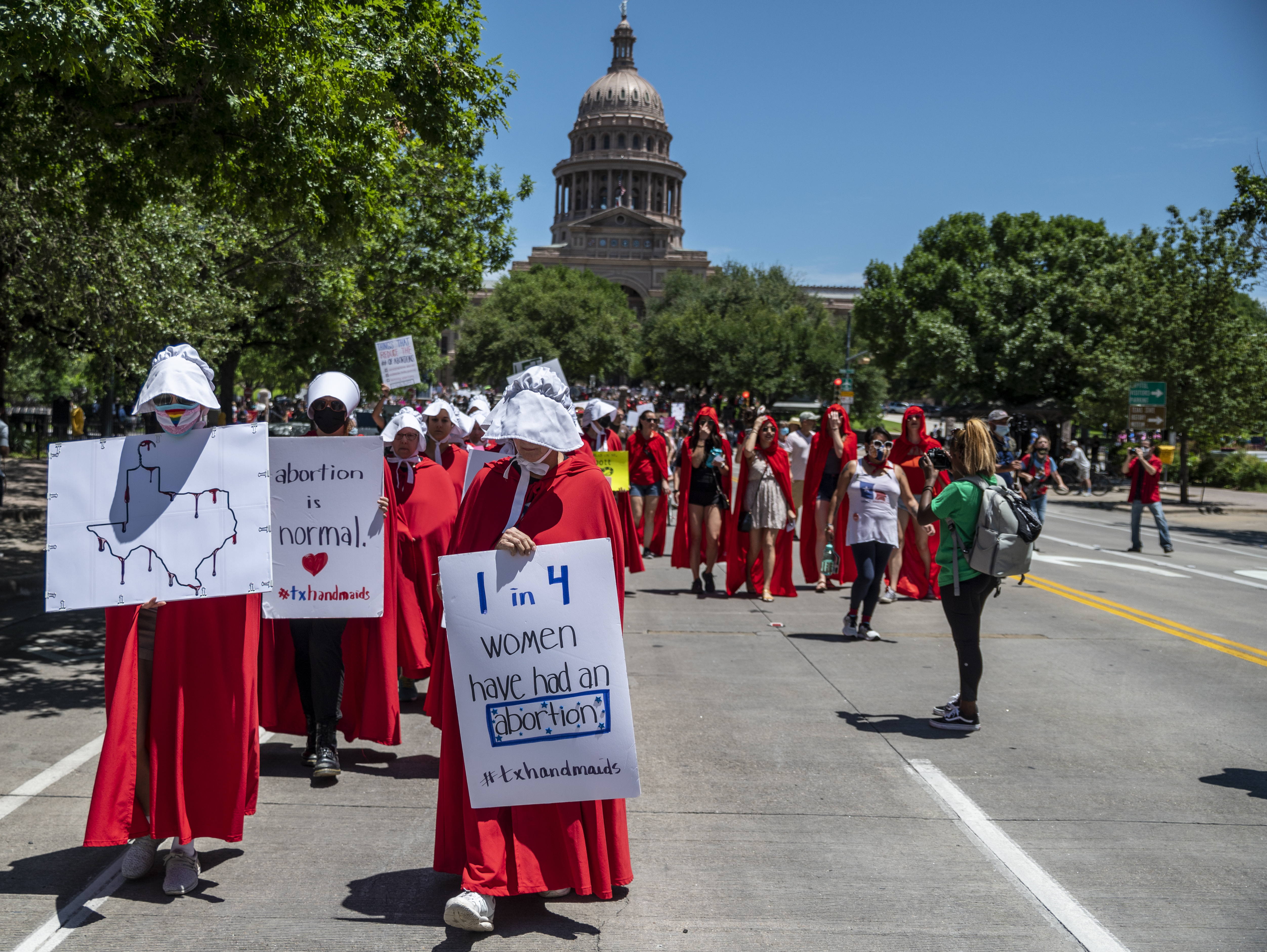 caption: Leaders at two dating app giants in Texas — Match Group and Bumble — have moved to set up funds to aid people affected by the state's new abortion ban. Here, abortion-rights supporters march near the Texas state capitol in Austin earlier this year.