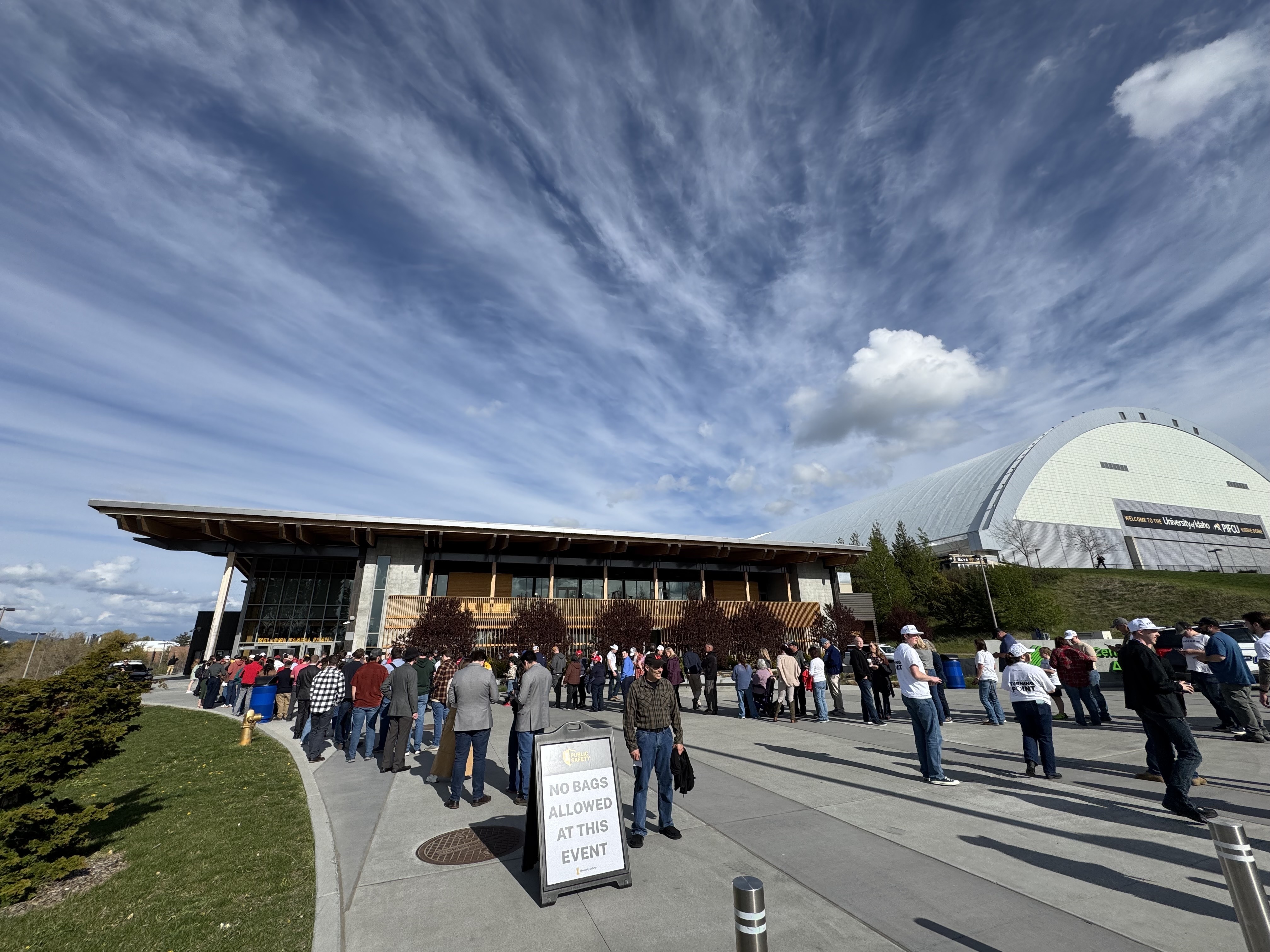 caption: People stand in line outside the Idaho Central Credit Union Arena at the University of Idaho on April 28 for the last stop on Turning Point USA's This is the Turning Point Tour of college campuses.