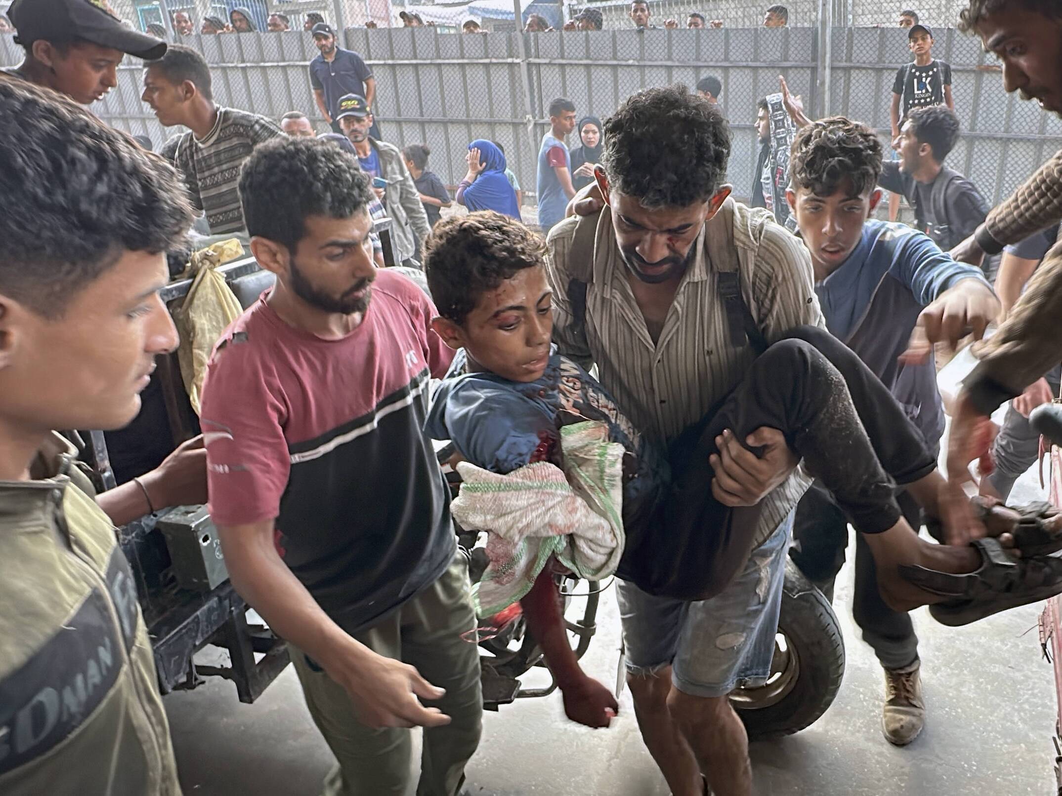 caption: Palestinians are brought to Nasser hospital in Khan Younis after being wounded or killed by Israeli forces while they tried to get food on Tuesday.