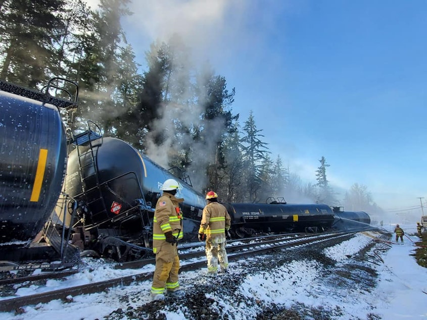 caption: Firefighters work on an oil train that derailed in Custer, Washington, on Dec. 22.