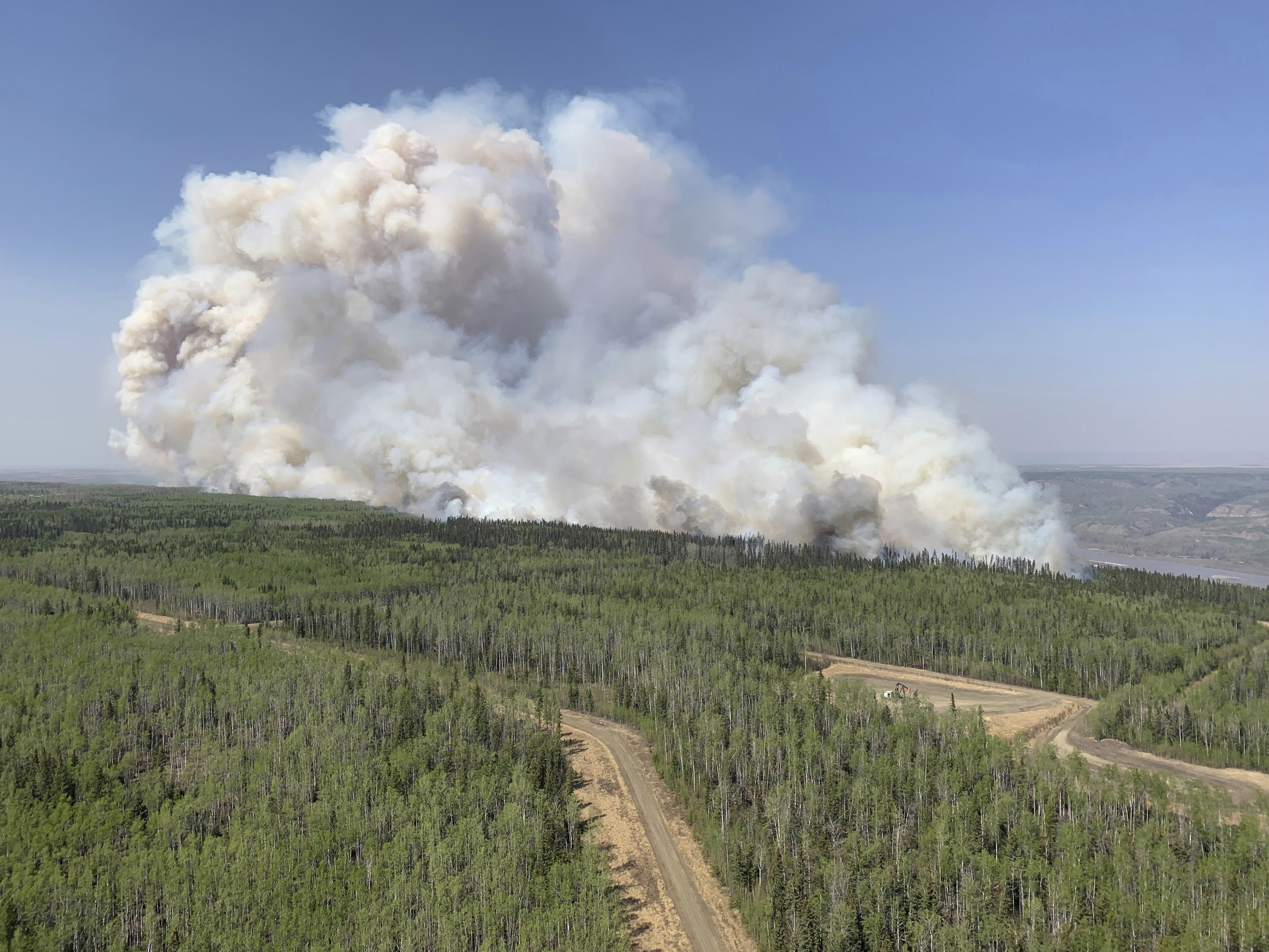 caption: A wildfire burns a section of forest in the Grande Prairie district of Alberta, Canada, on Saturday.