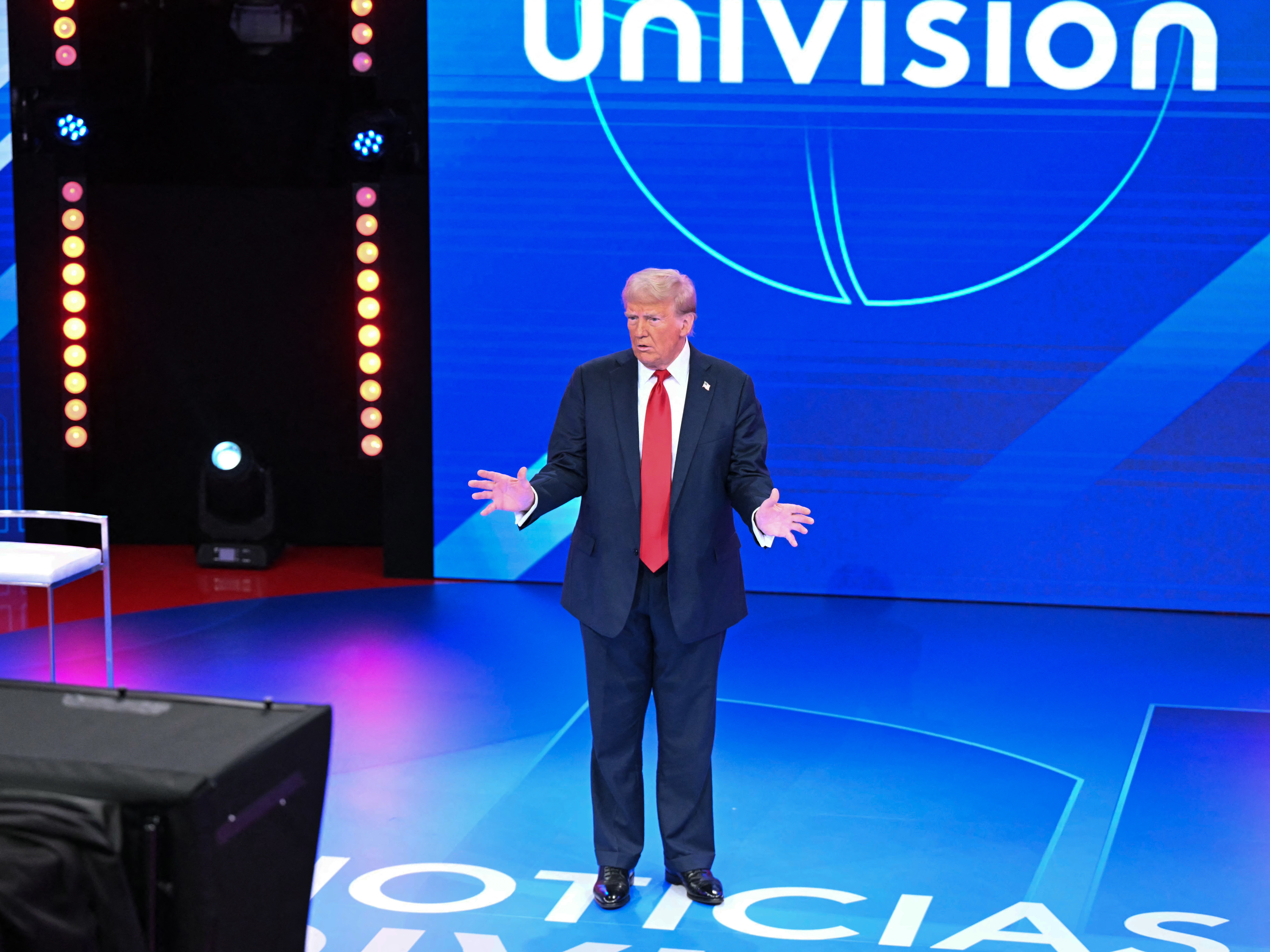 caption: Former President Donald Trump addresses a town hall hosted by Univision and moderated by Enrique Acevedo in Miami on Wednesday.