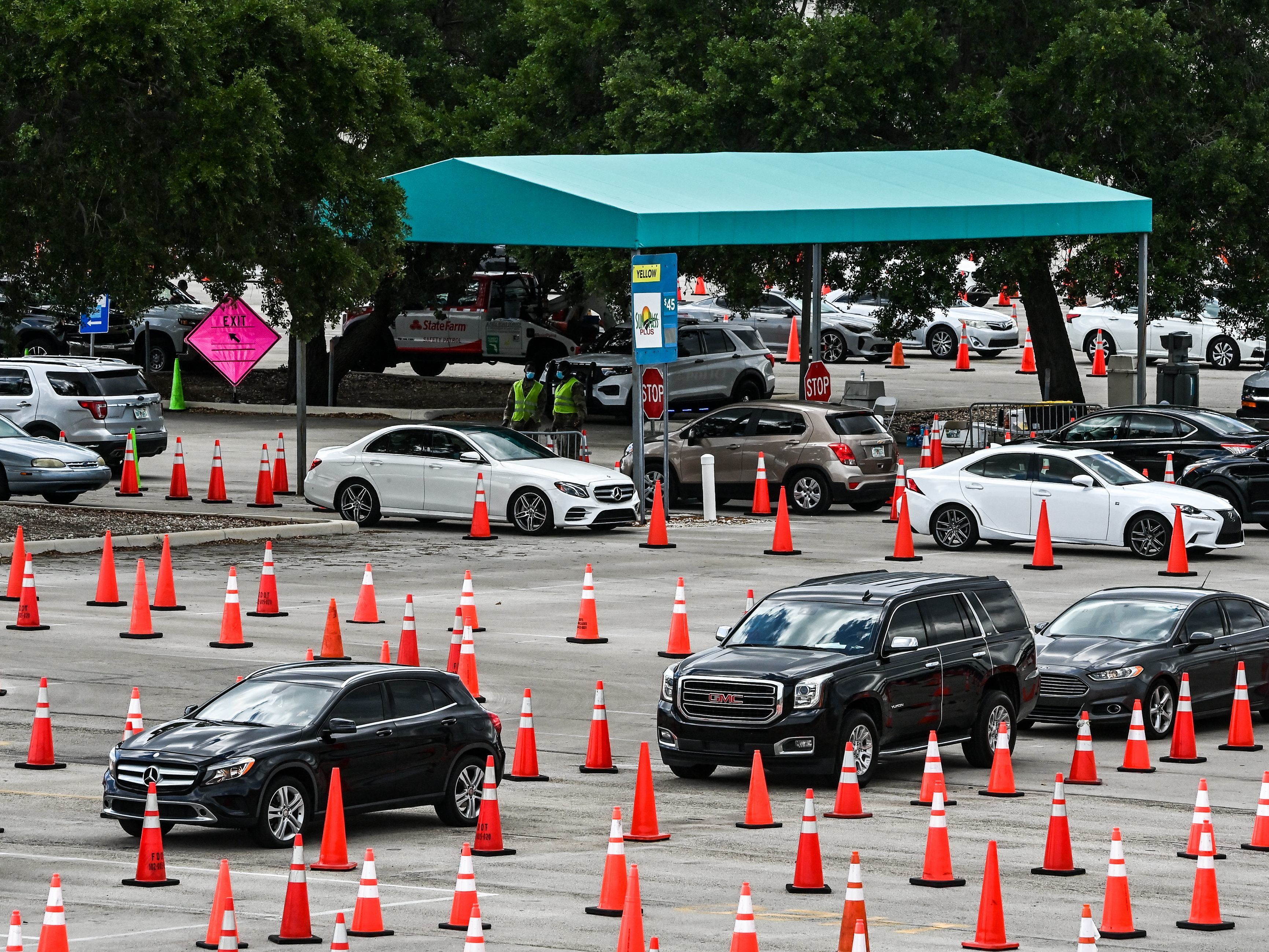 caption: People wait in their vehicles to get vaccinated last week at a drive-through site at Hard Rock Stadium in Miami Gardens, Fla. President Biden Tuesday announced an April 19 deadline for all states to open eligibility to individuals ages 18 and up.