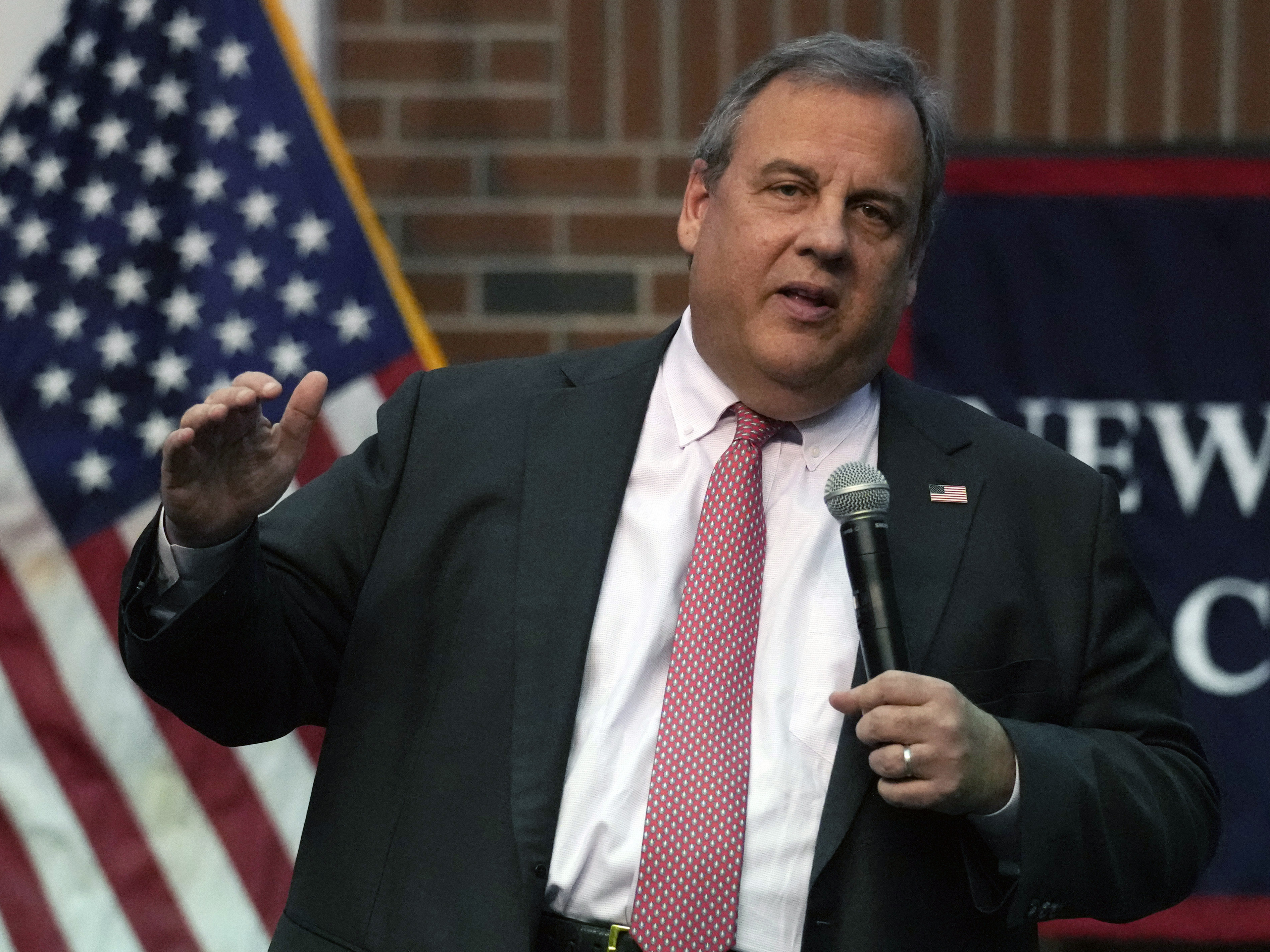 caption: Former New Jersey Gov. Chris Christie addresses a gathering during a town hall style meeting at New England College in Henniker, N.H., on April 20.