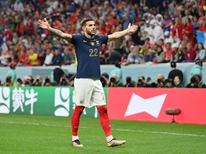caption: Theo Hernández of France celebrates after scoring the team's first goal during the 2022 World Cup semifinal between France and Morocco on December 14, 2022 in Al Khor, Qatar.