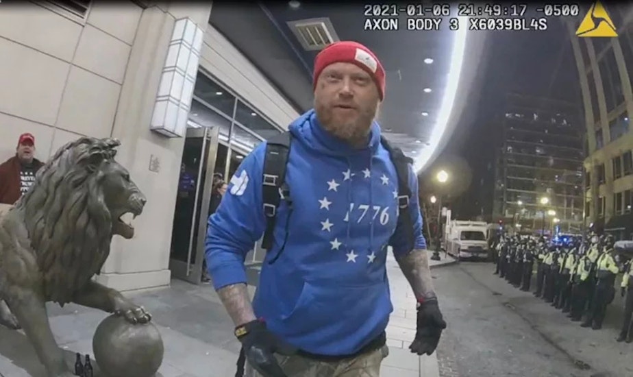 caption: Shane Jenkins, seen here in police bodycam footage from Jan. 6, 2021, was convicted of multiple charges in connection with the Capitol riot, including assaulting police. Months after receiving a pardon from President Trump, Jenkins visited the White House along with another former Jan. 6 defendant.