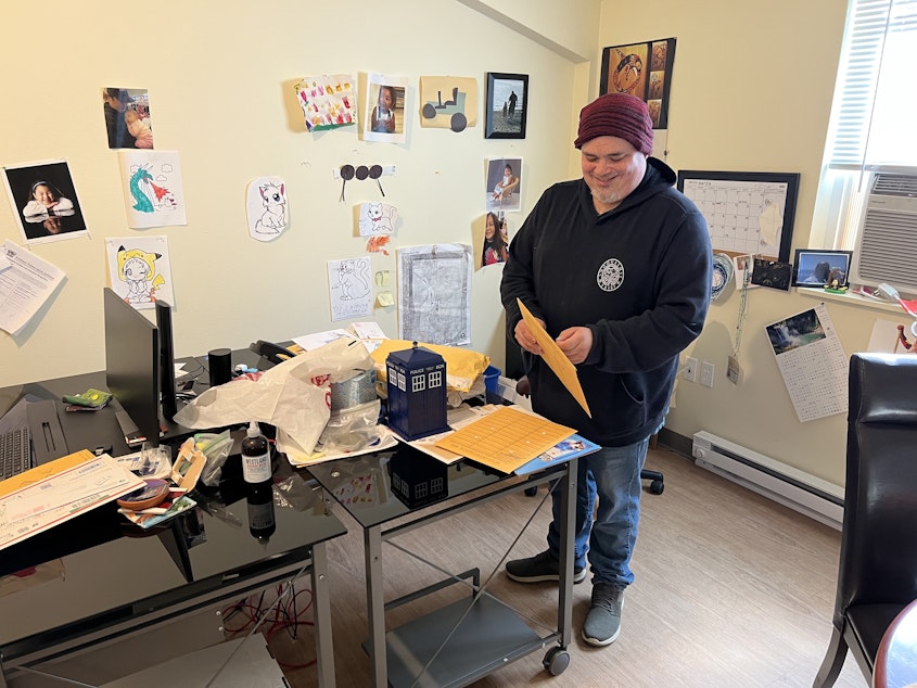 caption: Steven Moses is the director of archaeology and historic preservation and a member of the Snoqualmie Tribe. Here he's going through a pile of mail in his office. 