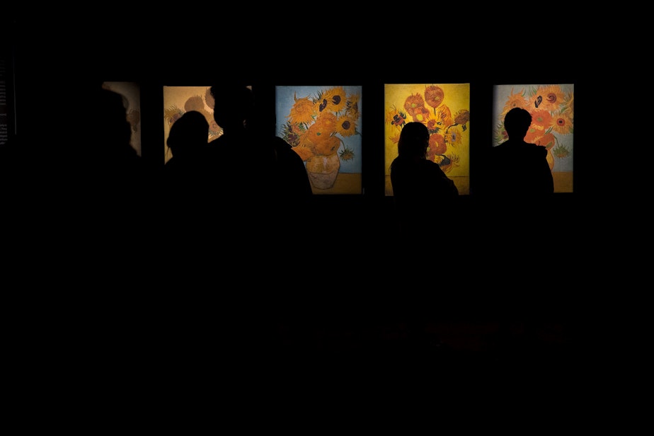 caption: Patrons take in various reproductions of Van Gogh's work at the immersive exhibit on Wednesday, October 27, 2021, in Seattle. 