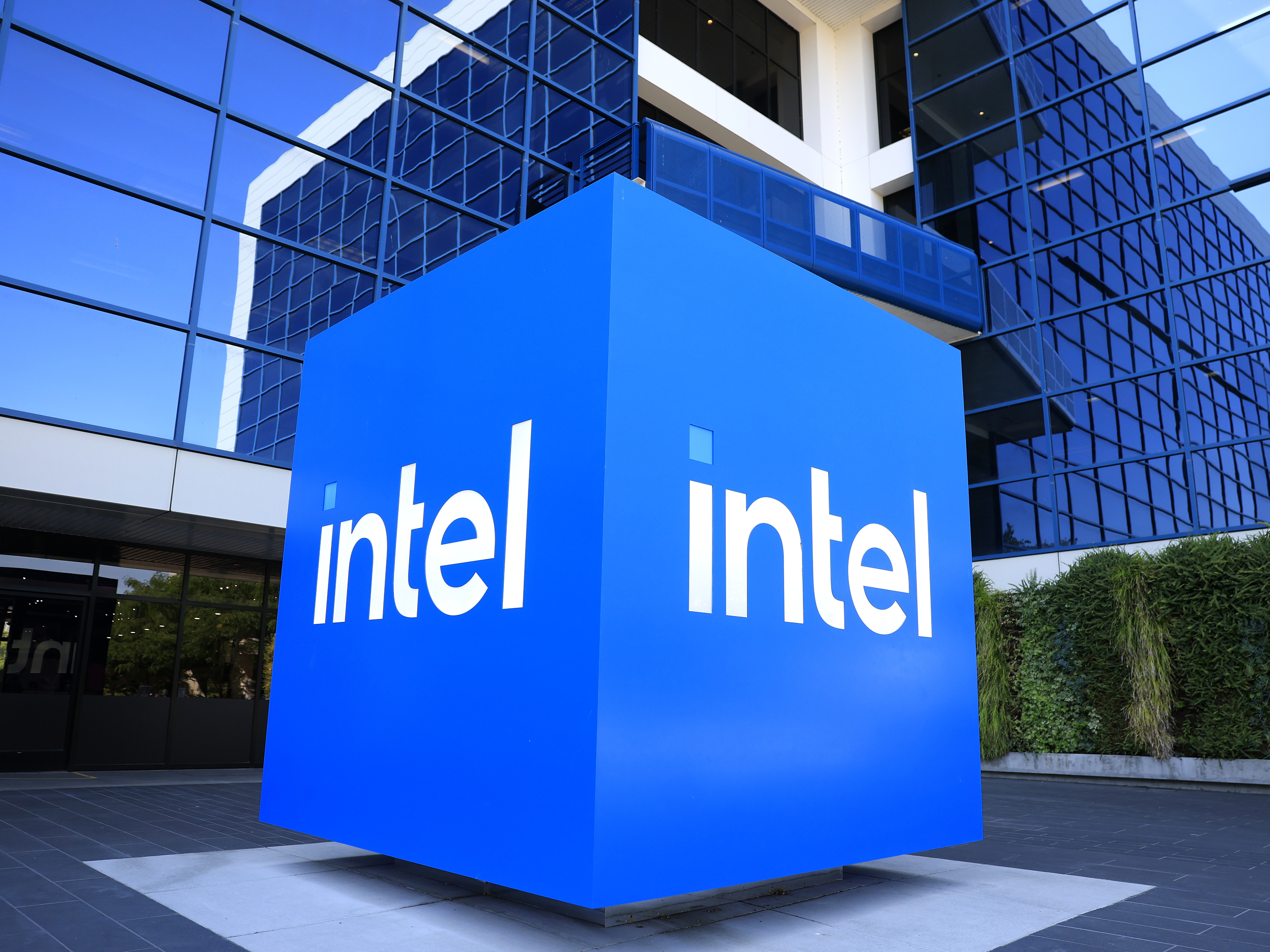 caption: The Intel logo is displayed on a sign in front of Intel headquarters on July 16, 2025 in Santa Clara, California.