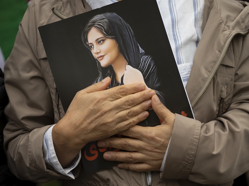 caption: A portrait of Mahsa Amini is held during a rally in Washington, on Oct. 1, 2022. Amini, who also went by her Kurdish name, Jina, died in police custody in Iran last year, sparking worldwide protests against the country's conservative Islamic theocracy. She was awarded the European Union's top human rights prize on Thursday, Oct. 19, 2023.