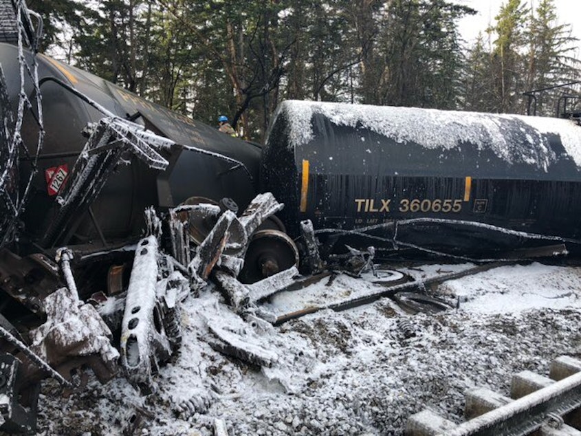 caption: Derailed tanker cars in Custer on Dec. 23, each holding about 29,000 gallons of crude oil