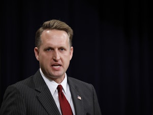caption: Former acting Assistant Attorney General for Civil Rights John Gore speaks at the Justice Department in 2018 in Washington, D.C. Gore and other Trump administration officials are accused of providing false or misleading statements about the origins of a citizenship question they tried to get on the 2020 census.
