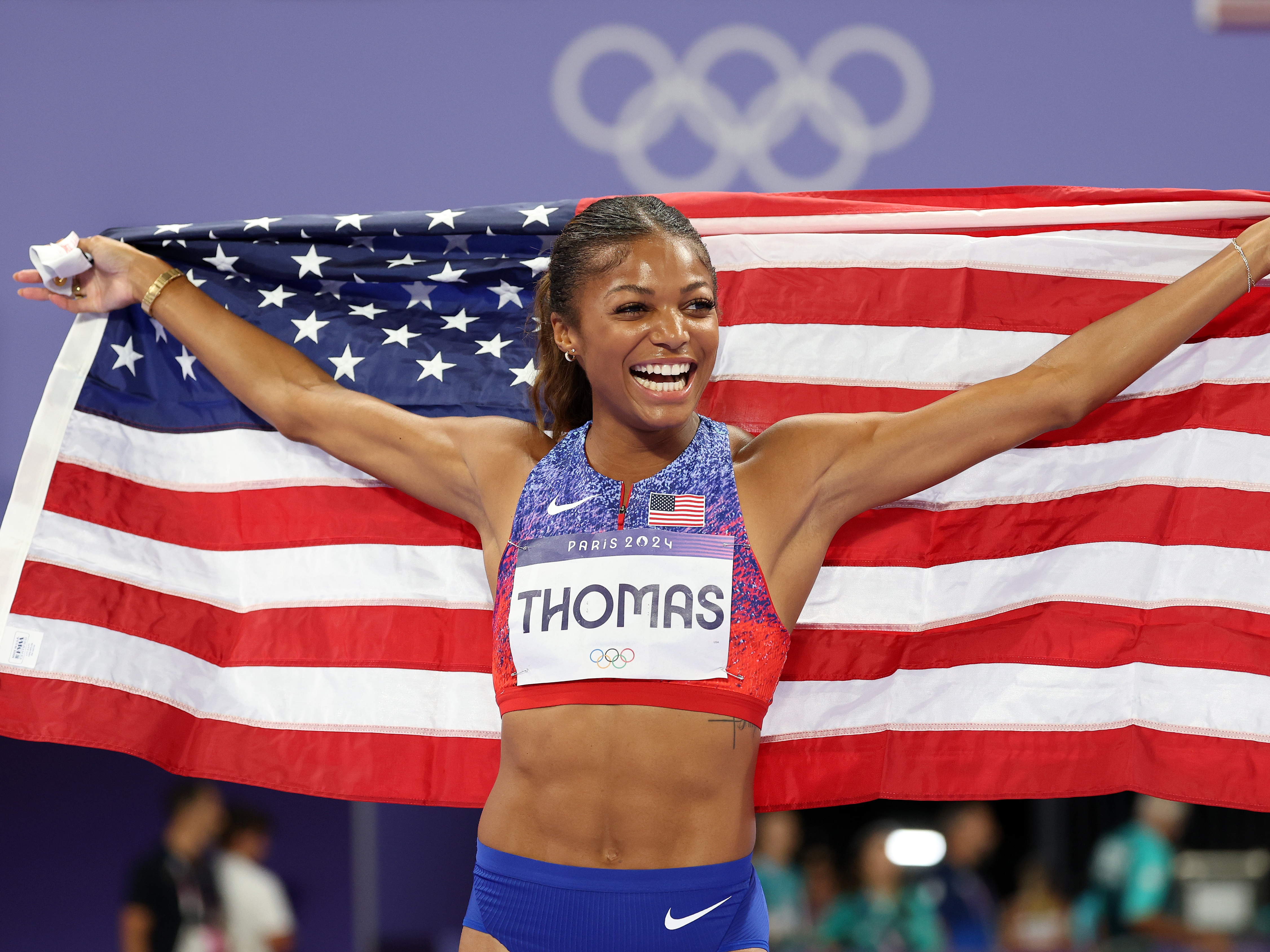 caption: Sprinter Gabby Thomas of the U.S. celebrates winning the gold medal after competing in the women's 200m final on Tuesday at the Paris Olympic Games at Stade de France.