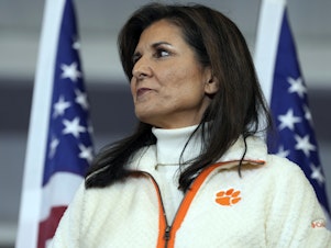 caption: Republican presidential candidate former UN Ambassador Nikki Haley waits as she's introduced at a campaign rally on Tuesday in Clemson, S.C.