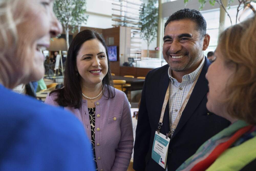 caption: State Reps. Armando Walle, center right, and Ana Hernandez, center left, both Democrats from Houston, talk with past presidents of the National Conference of State Legislatures, Jane Campbell, left, and Leticia Van de Putte, right, during the Legislative Summit, Monday, Aug. 4, 2025, in Boston. (Michael Dwyer/AP)