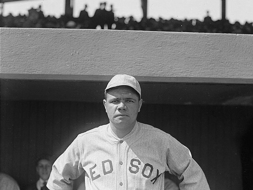 caption: Babe Ruth, a pitcher for the Boston Red Sox, in 1918. That year, World War I and the Spanish flu pandemic slashed MLB game attendance by over half from what it was in the previous season.