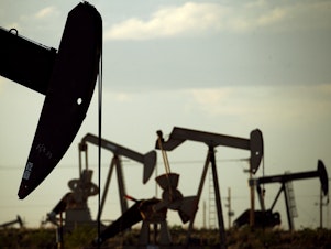 caption: Pumpjacks work in a New Mexico field.