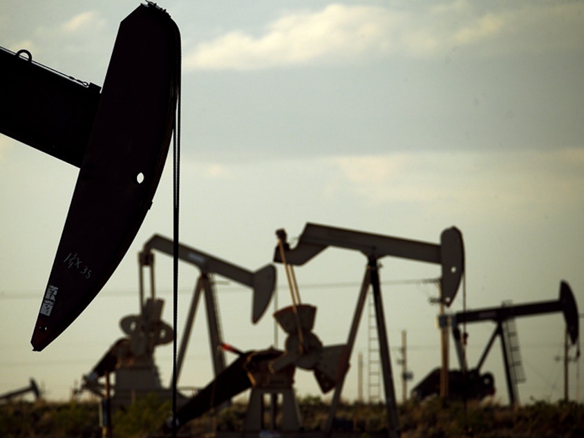 caption: Pumpjacks work in a New Mexico field.