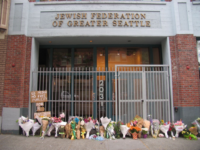 caption: Flowers outside Jewish Federation Building commemorate the 2006 hate-crime shooting .