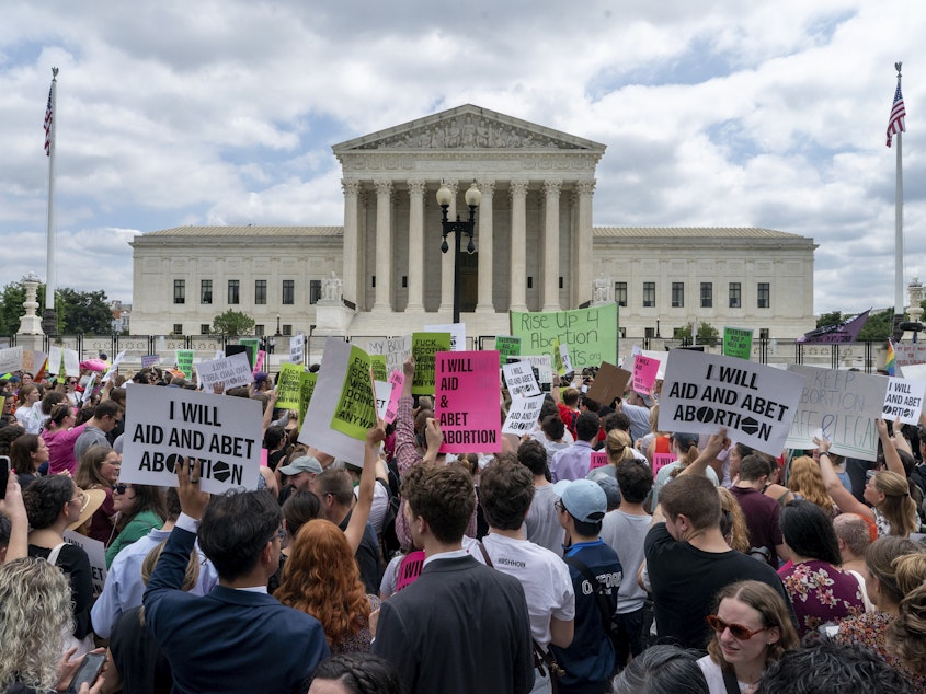 caption: A slew of companies will cover travel expenses for employees that have to travel out of their state for an abortion after the Supreme Court overturned federal protections for the procedure.