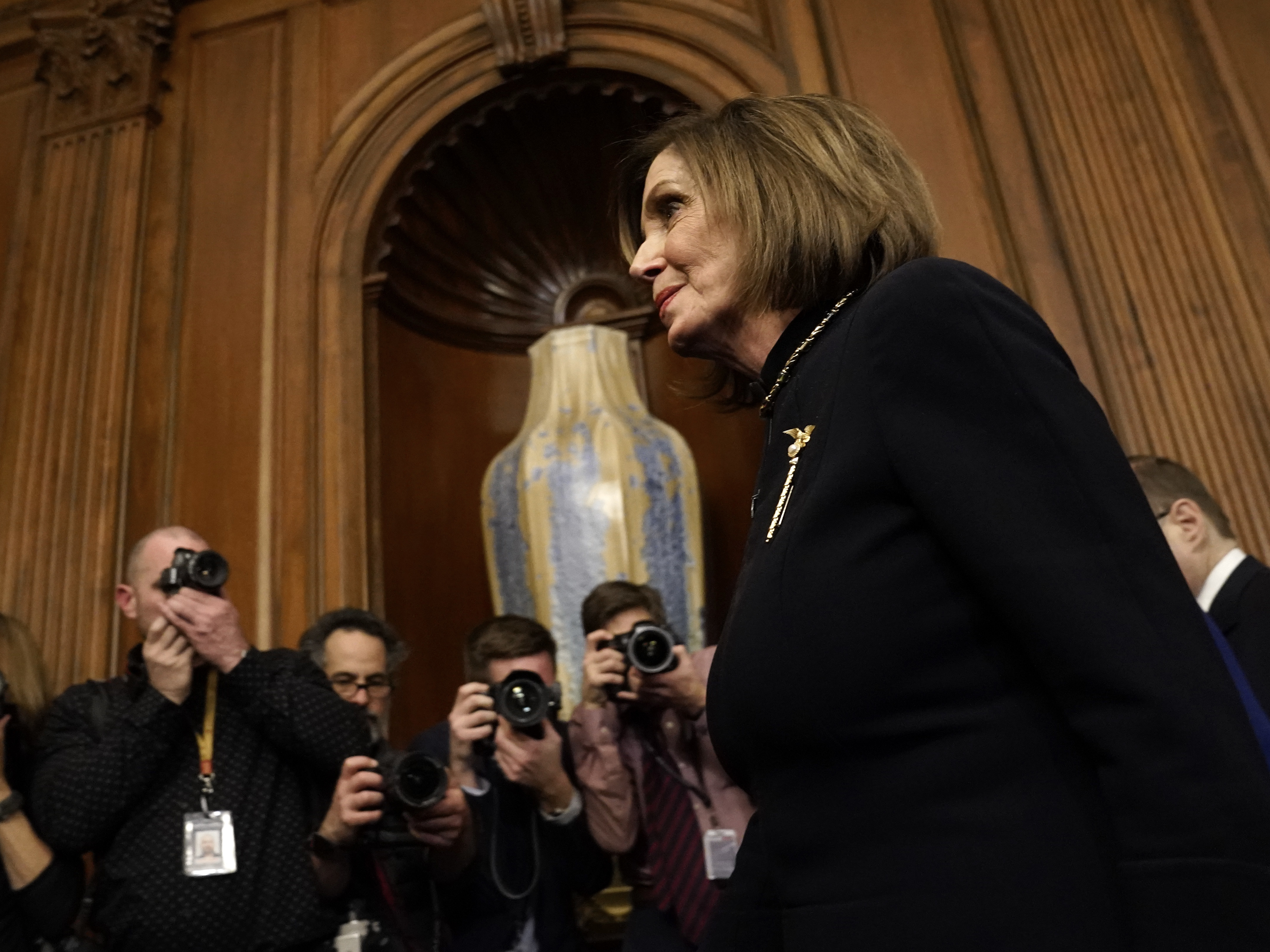 caption: House Speaker Nancy Pelosi departs a press conference following the impeachment vote in the House of Representatives against  President Trump Wednesday evening.