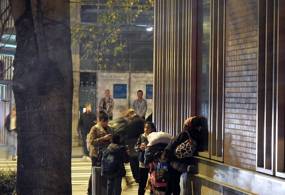 caption: Homeless families outside a shelter in downtown Seattle.