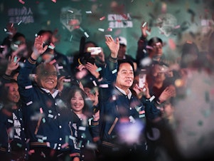 caption: Lai Ching-te, Taiwan's president-elect (center) appears at an election night rally outside the Democratic Progressive Party headquarters in Taipei, Taiwan, on Saturday.