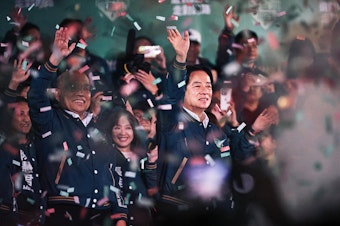 caption: Lai Ching-te, Taiwan's president-elect (center) appears at an election night rally outside the Democratic Progressive Party headquarters in Taipei, Taiwan, on Saturday.