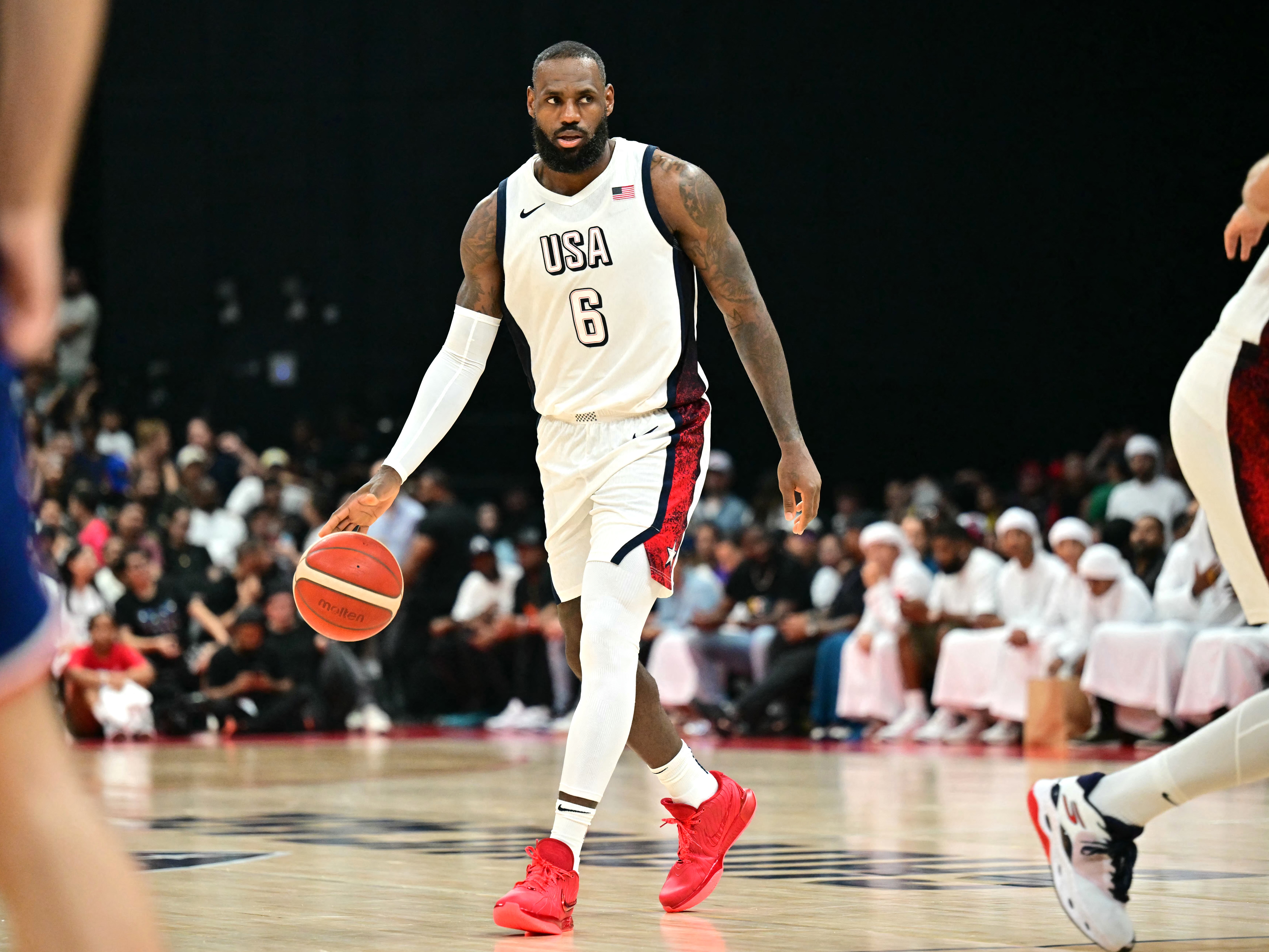 caption: LeBron James during a friendly match earlier this month between the U.S. and Serbia. James, 39, will carry the U.S. flag at the Paris Olympics opening ceremony on Friday.
