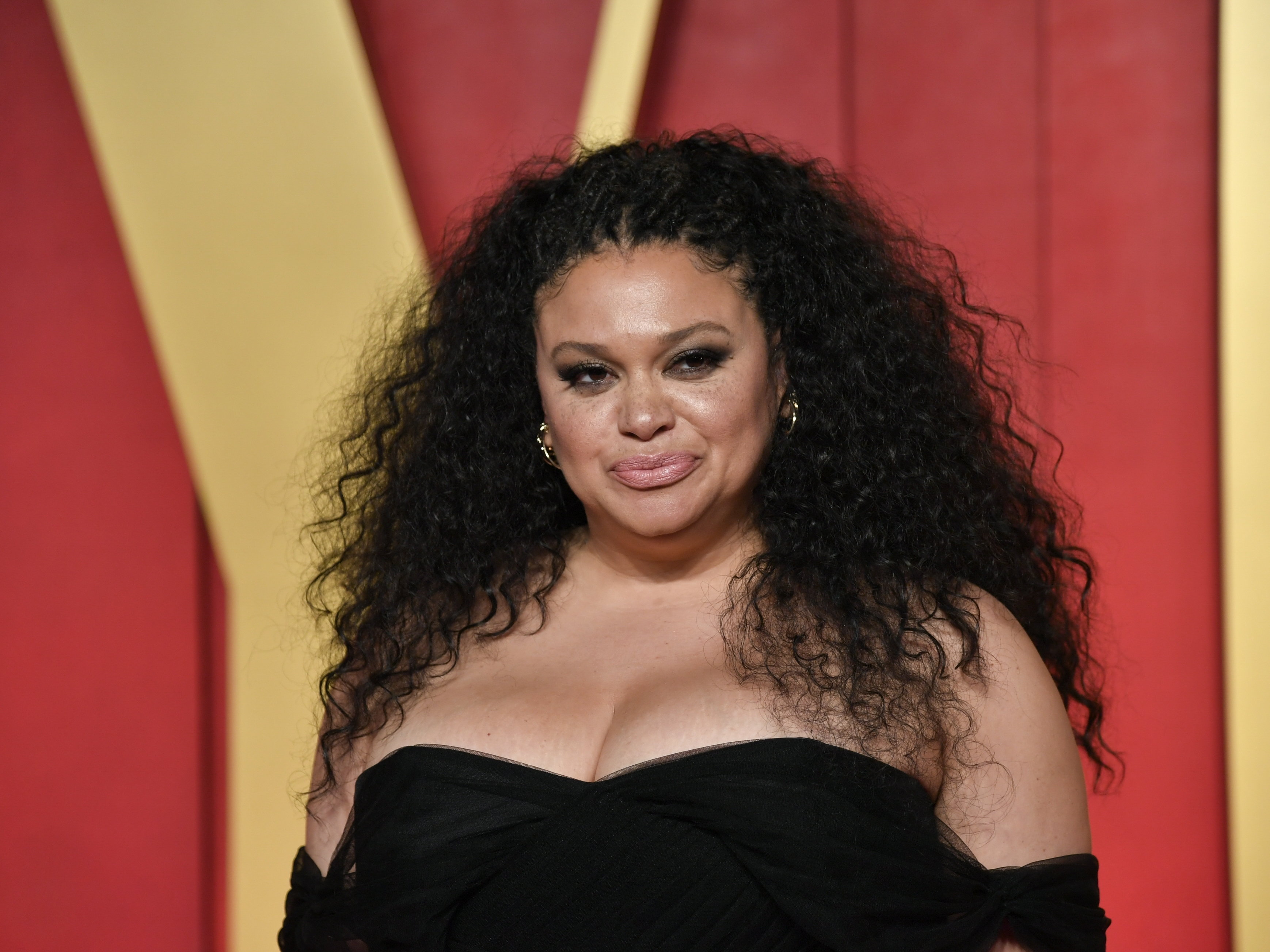 caption: Michelle Buteau arrives at the <em>Vanity Fair </em>Oscar Party on March 10.