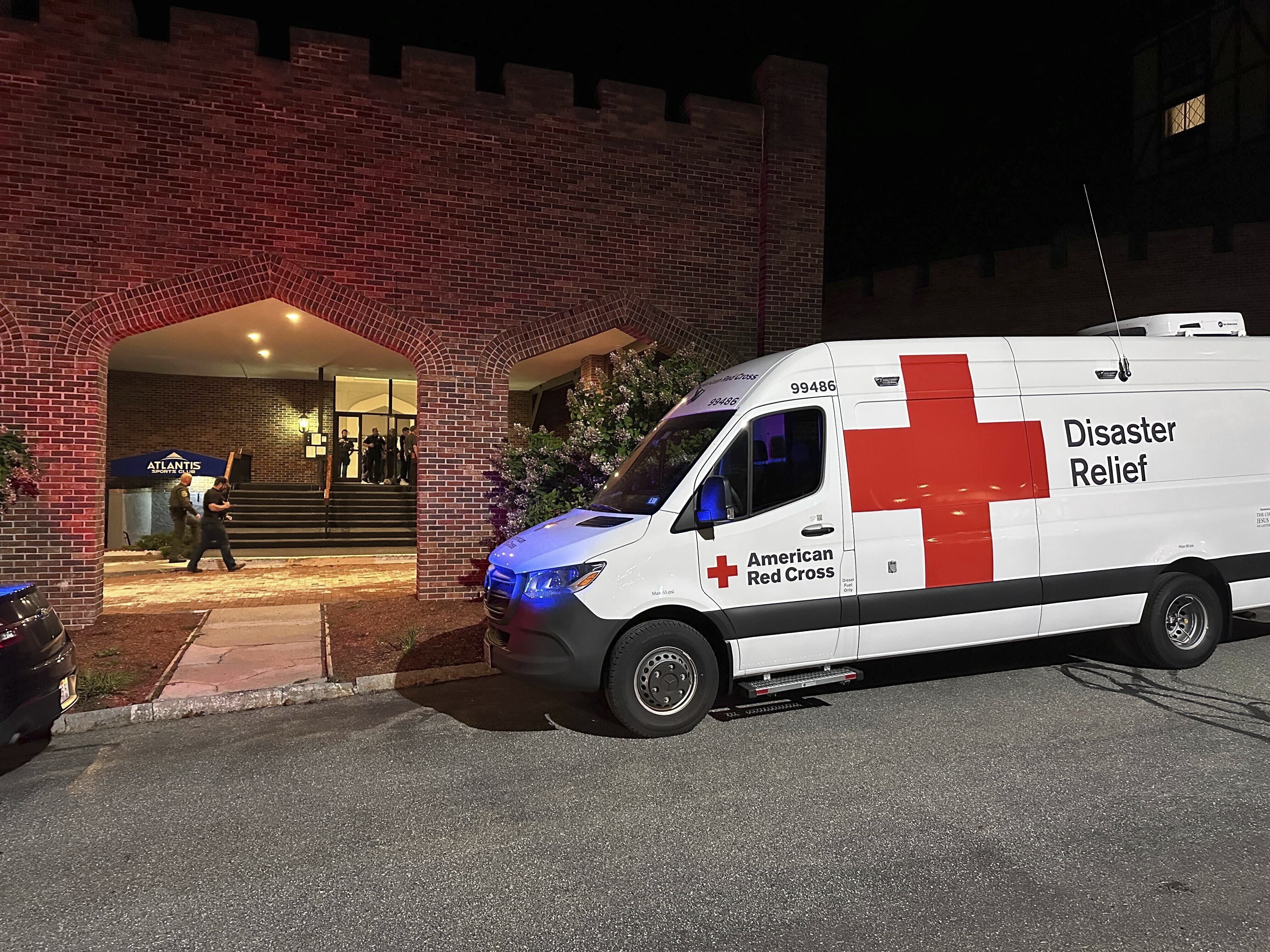 caption: An American Red Cross Disaster Relief van is parked outside a hotel that is acting as a reunification center after a shooting at a country club in Nashua, New Hampshire, on Sept. 20, 2025.