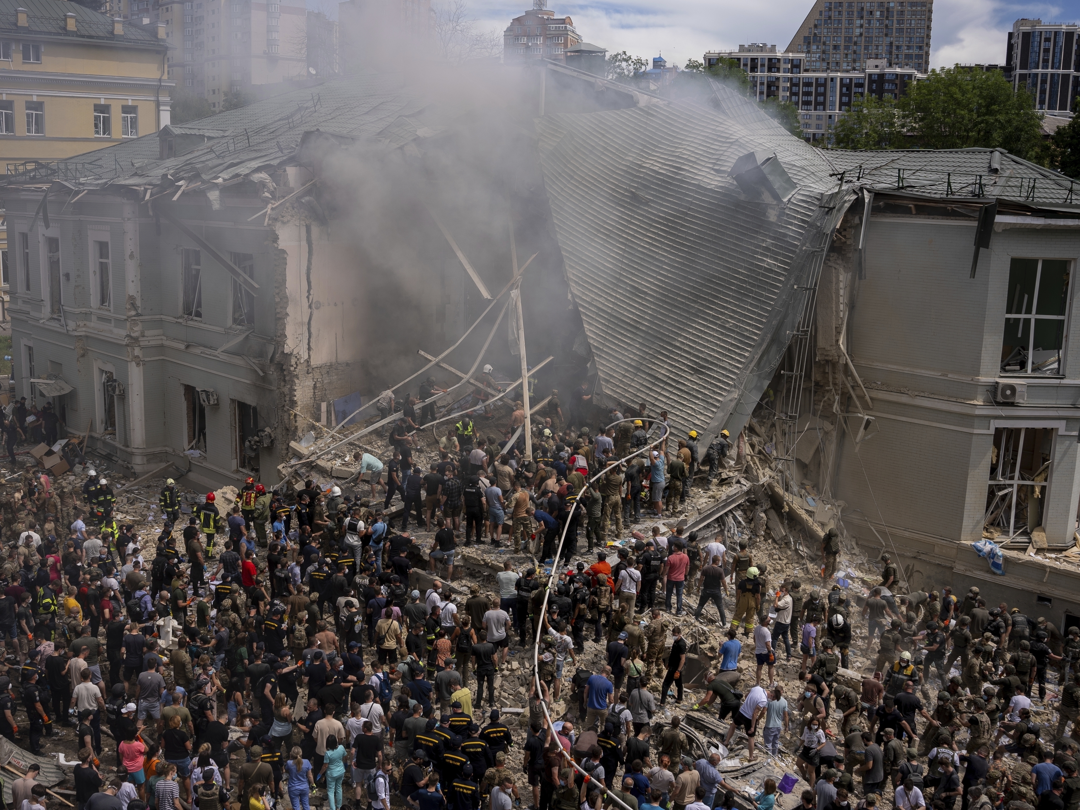 caption: Emergency workers respond at the Okhmatdyt children's hospital hit by Russian missiles, in Kyiv, Ukraine, Monday.