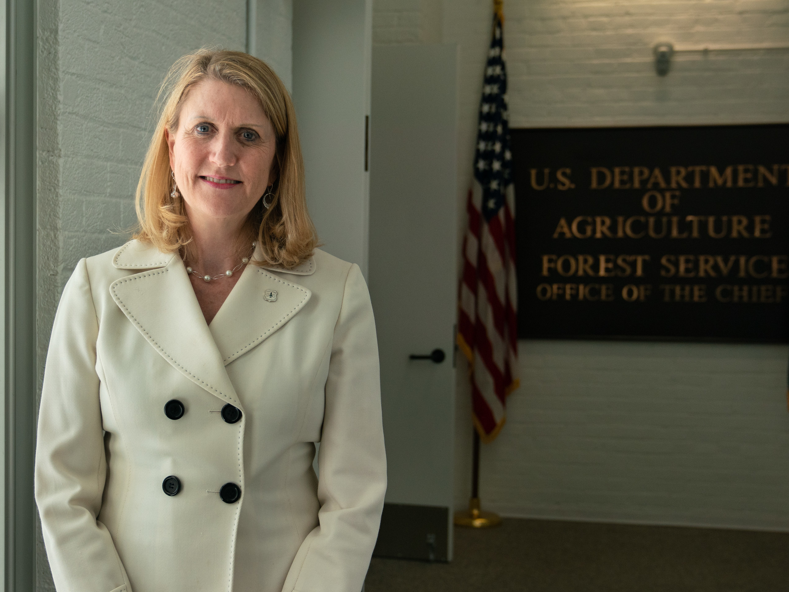 caption: Vicki Christiansen, the chief of the U.S. Department of Agriculture's Forest Service, stands outside of her office in Washington, D.C.