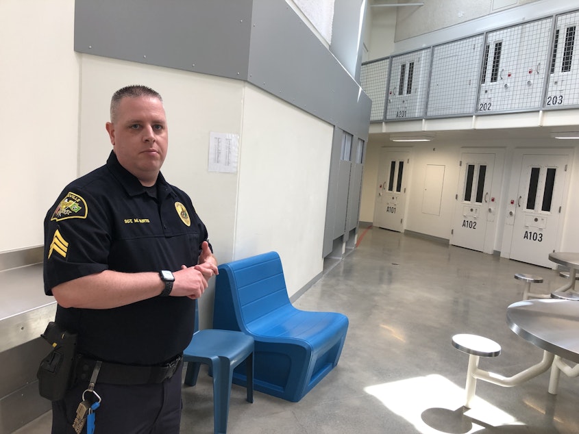 caption: Sgt. Michael Burtis in a pod of the Marysville Municipal Jail. He estimated that up to 90% of people housed there have some kind of substance use disorder. 