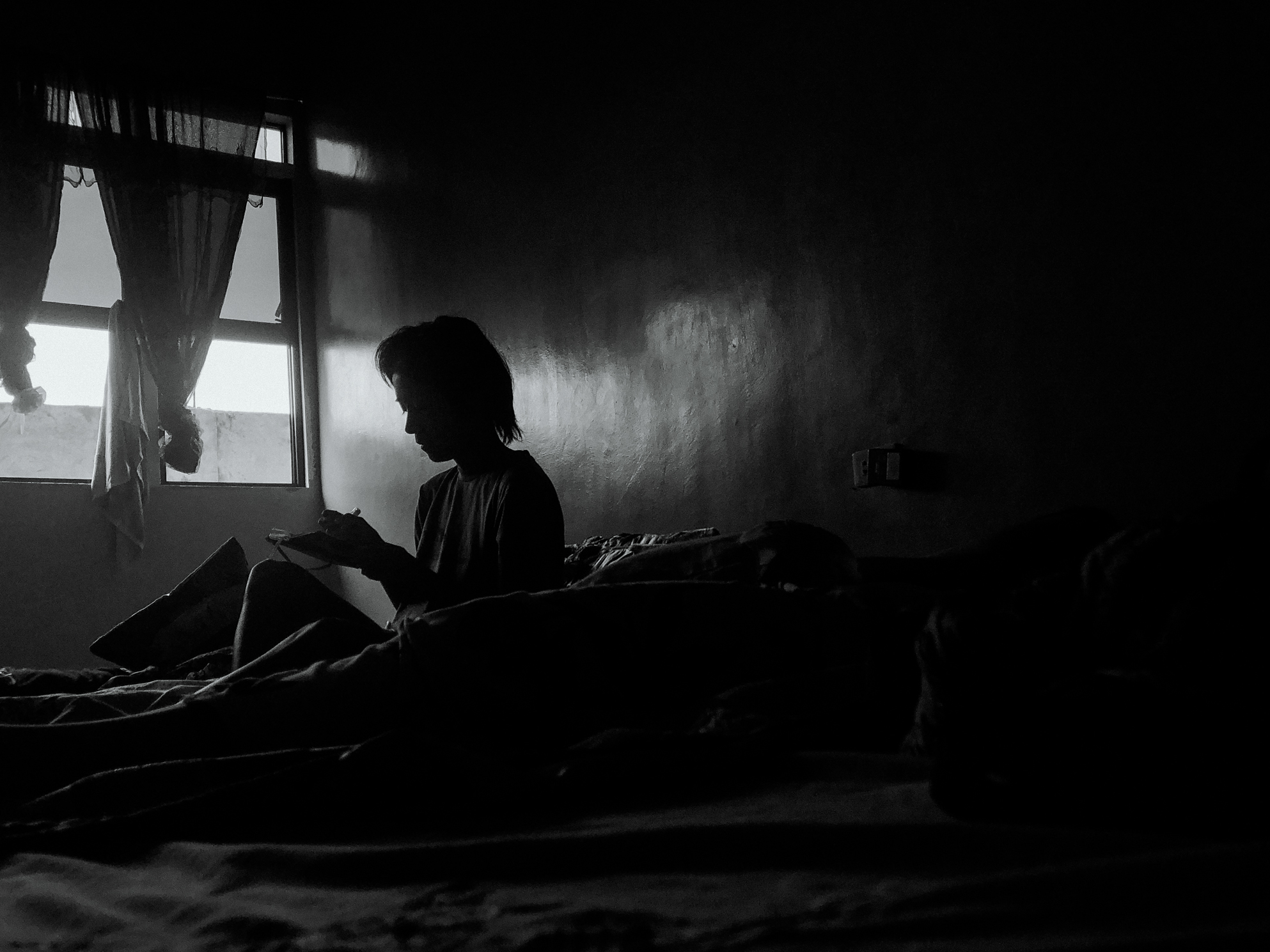 caption: My trauma ebbs and flows. When these emotions demand to be felt, I respond with a click of a shutter or the scratching of a pen.