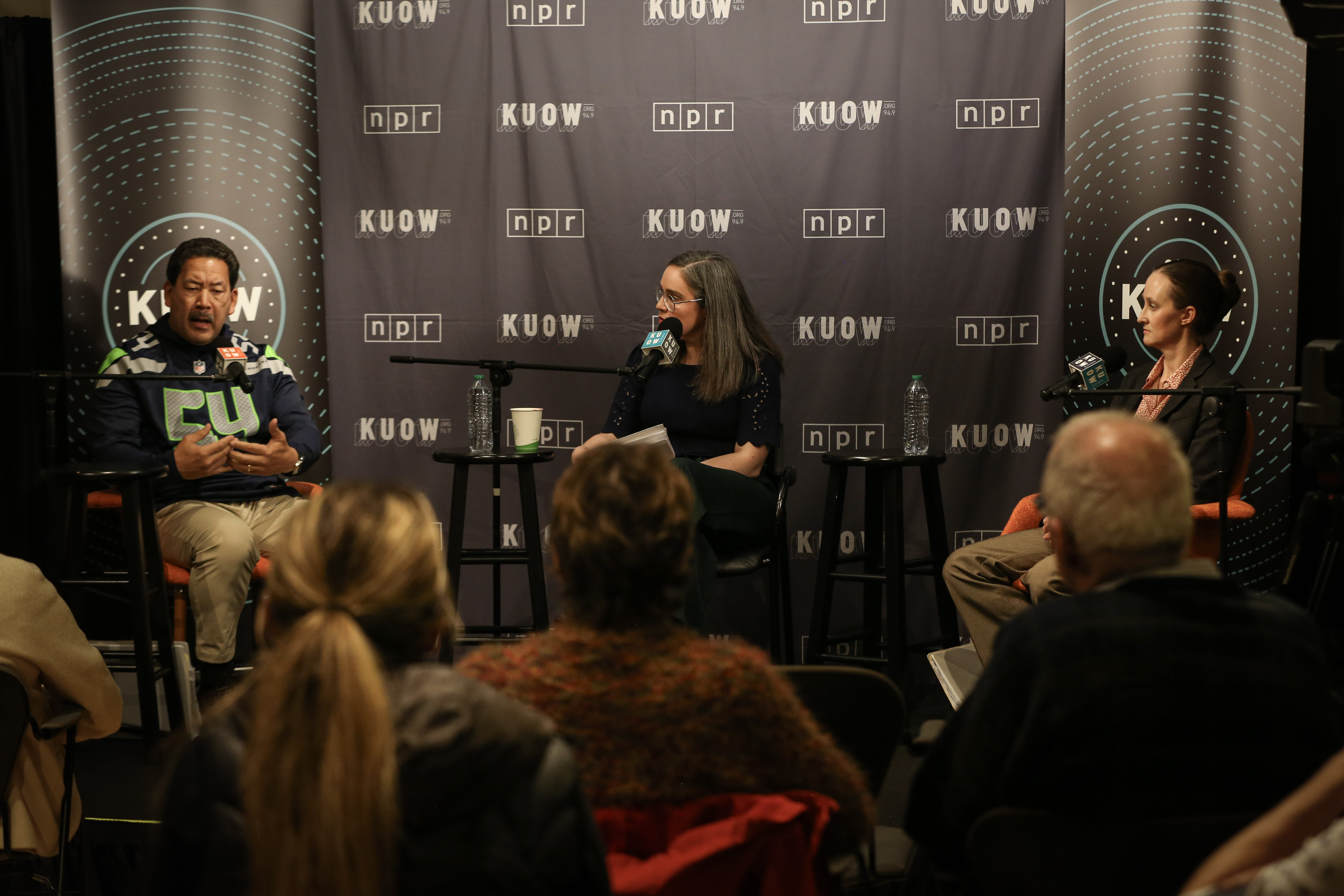 caption: Mayor candidate Katie Wilson (on the right) debates incumbent Mayor Bruce Harrell (left) during a mayoral debate moderated by Soundside host Libby Denkmann at the KUOW Studios in Seattle on Oct. 20, 2025. 