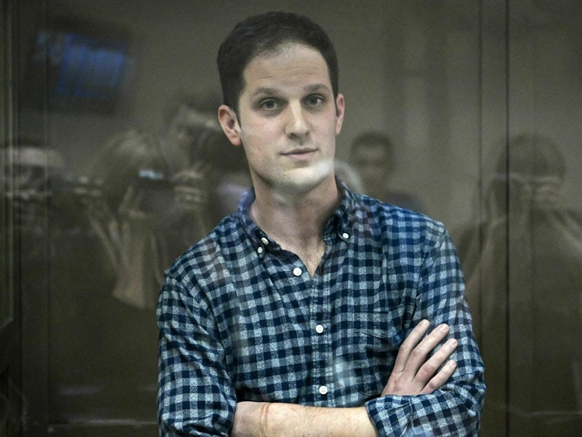 caption: U.S. journalist Evan Gershkovich, arrested on espionage charges, stands inside a defendants' cage before a hearing to consider an appeal on his arrest at the Moscow City Court on Tuesday.